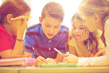 Image showing group of students talking and writing at school