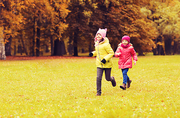 Image showing group of happy little girls running outdoors