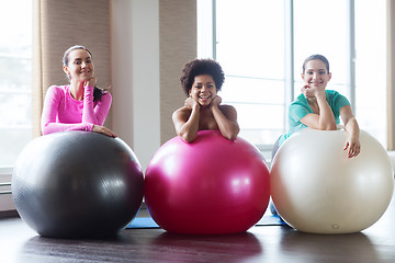 Image showing group of smiling women with exercise balls in gym