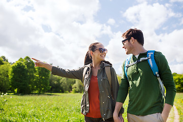 Image showing happy couple with backpacks hiking outdoors