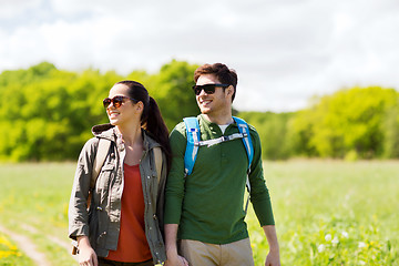 Image showing happy couple with backpacks hiking outdoors