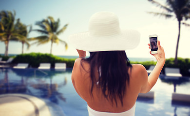 Image showing woman taking selfie with smartphone on beach