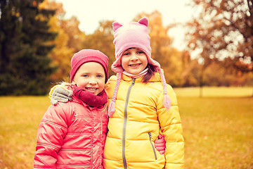 Image showing two happy little girls hugging in autumn park