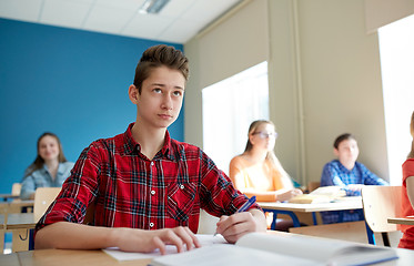 Image showing group of students with books at school lesson