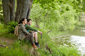 Image showing smiling couple with backpacks in nature