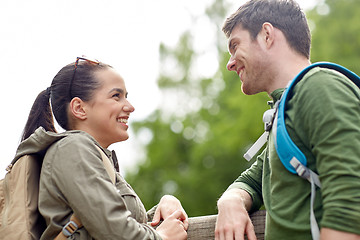 Image showing smiling couple with backpacks in nature