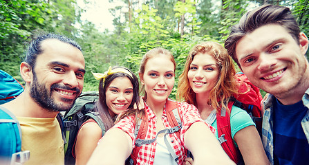 Image showing friends with backpack taking selfie in wood