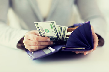 Image showing close up of woman hands with wallet and money