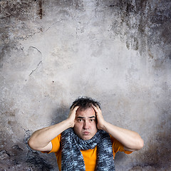 Image showing Sulky Man Clasping His Head With Both Hands