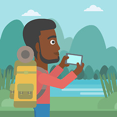 Image showing Man with backpack taking photo.