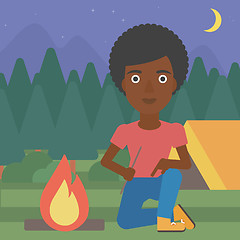 Image showing Woman kindling campfire vector illustration.