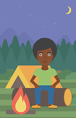 Image showing Woman sitting on log in the camping.