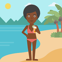 Image showing Woman with cocktail on the beach.