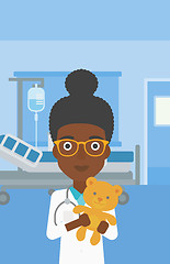 Image showing Pediatrician doctor holding teddy bear.