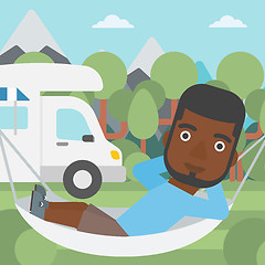 Image showing Man lying in hammock in front of motor home.