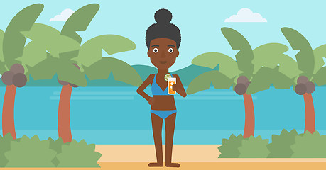 Image showing Woman with cocktail on the beach.