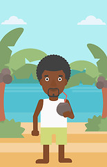 Image showing Man drinking coconut cocktail on the beach.