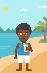 Image showing Man with cocktail on the beach.