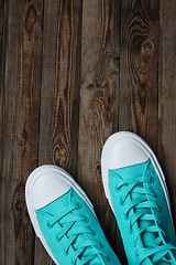 Image showing sneakers on empty wooden surface