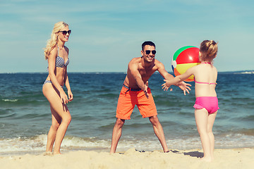 Image showing happy family playing with inflatable ball on beach