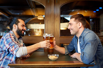 Image showing happy male friends drinking beer at bar or pub