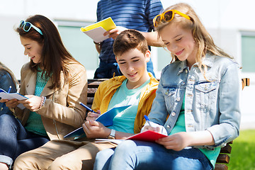 Image showing group of students with notebooks at school yard