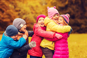 Image showing group of happy children hugging in autumn park