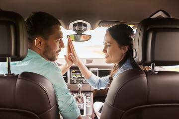 Image showing happy man and woman driving in car