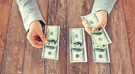 Image showing close up of woman hands counting us dollar money