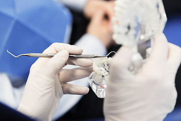 Image showing close up of dentist with teeth and dental probe