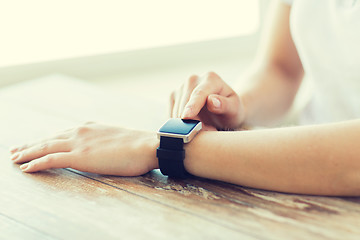 Image showing close up of hands setting smart watch