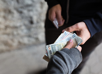 Image showing close up of addict buying dose from drug dealer