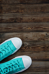 Image showing sneakers on empty wooden floor