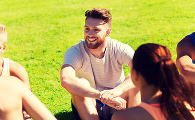 Image showing group of happy friends or sportsmen outdoors