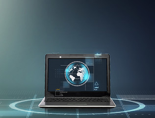 Image showing laptop computer with earth globe on screen