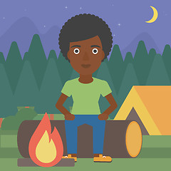 Image showing Woman sitting on log in the camping.