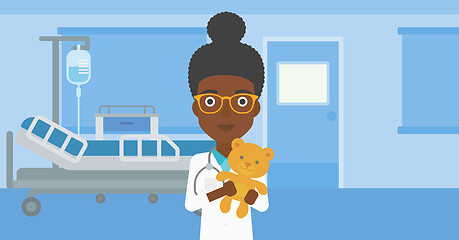 Image showing Pediatrician doctor holding teddy bear.