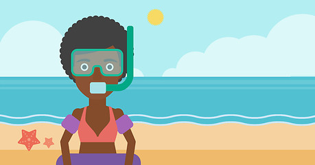 Image showing Woman with snorkeling equipment on the beach.