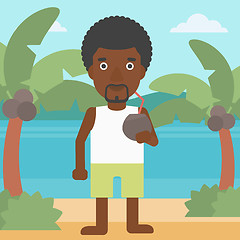 Image showing Man drinking coconut cocktail on the beach.