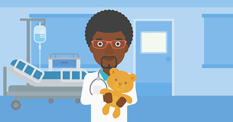 Image showing Pediatrician doctor holding teddy bear.