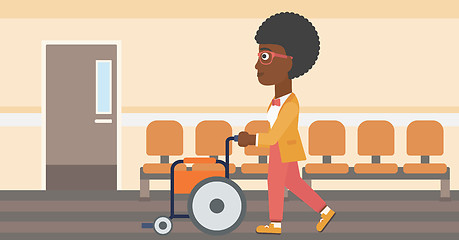Image showing Woman pushing wheelchair.