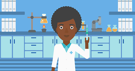 Image showing Laboratory assistant with syringe in lab.