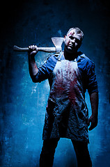 Image showing Bloody Halloween theme: crazy killer as butcher with an ax