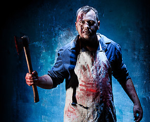 Image showing Bloody Halloween theme: crazy killer as butcher with an ax