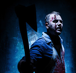 Image showing Bloody Halloween theme: crazy killer as butcher with an ax