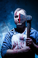 Image showing Bloody Halloween theme: crazy killer as butcher with an ax