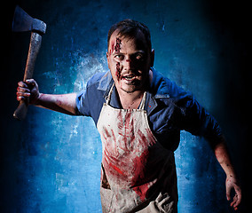 Image showing Bloody Halloween theme: crazy killer as butcher with an ax