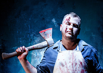 Image showing Bloody Halloween theme: crazy killer as butcher with an ax