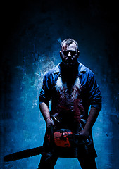 Image showing Bloody Halloween theme: crazy killer as butcher with electric saw