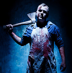 Image showing Bloody Halloween theme: crazy killer as butcher with an ax